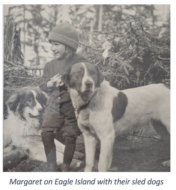 Margaret as a girl on Eagle Island with 2 sled dogs